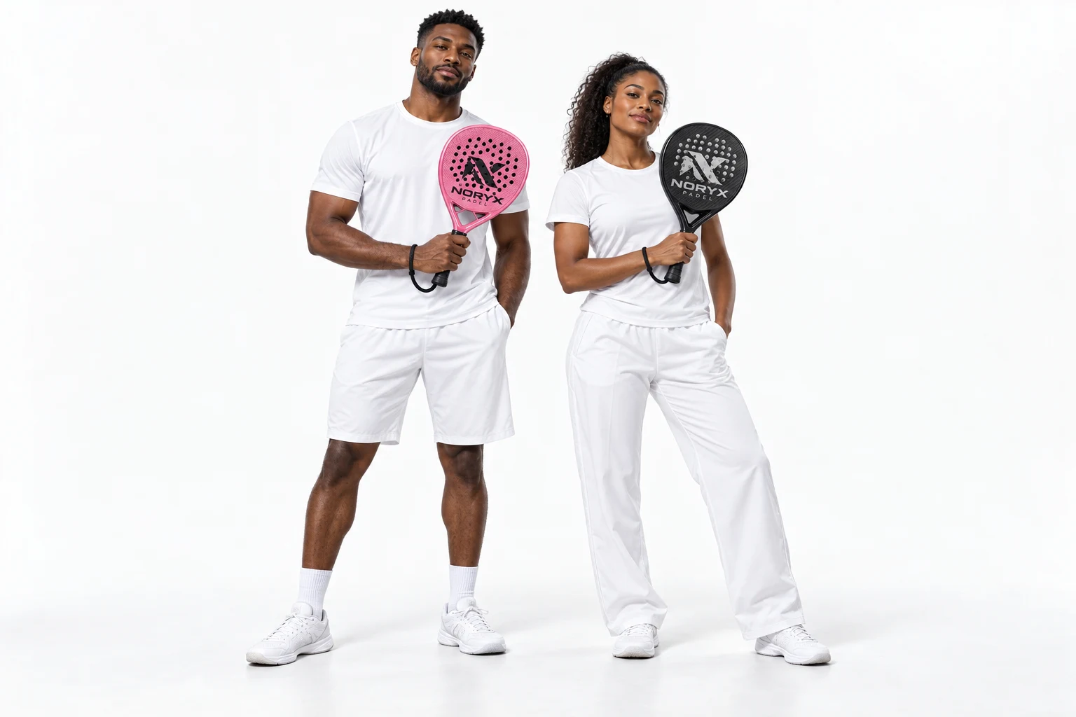 Two players in white sportswear, a man holding a pink NORYX racket and a woman holding a black NORYX racket